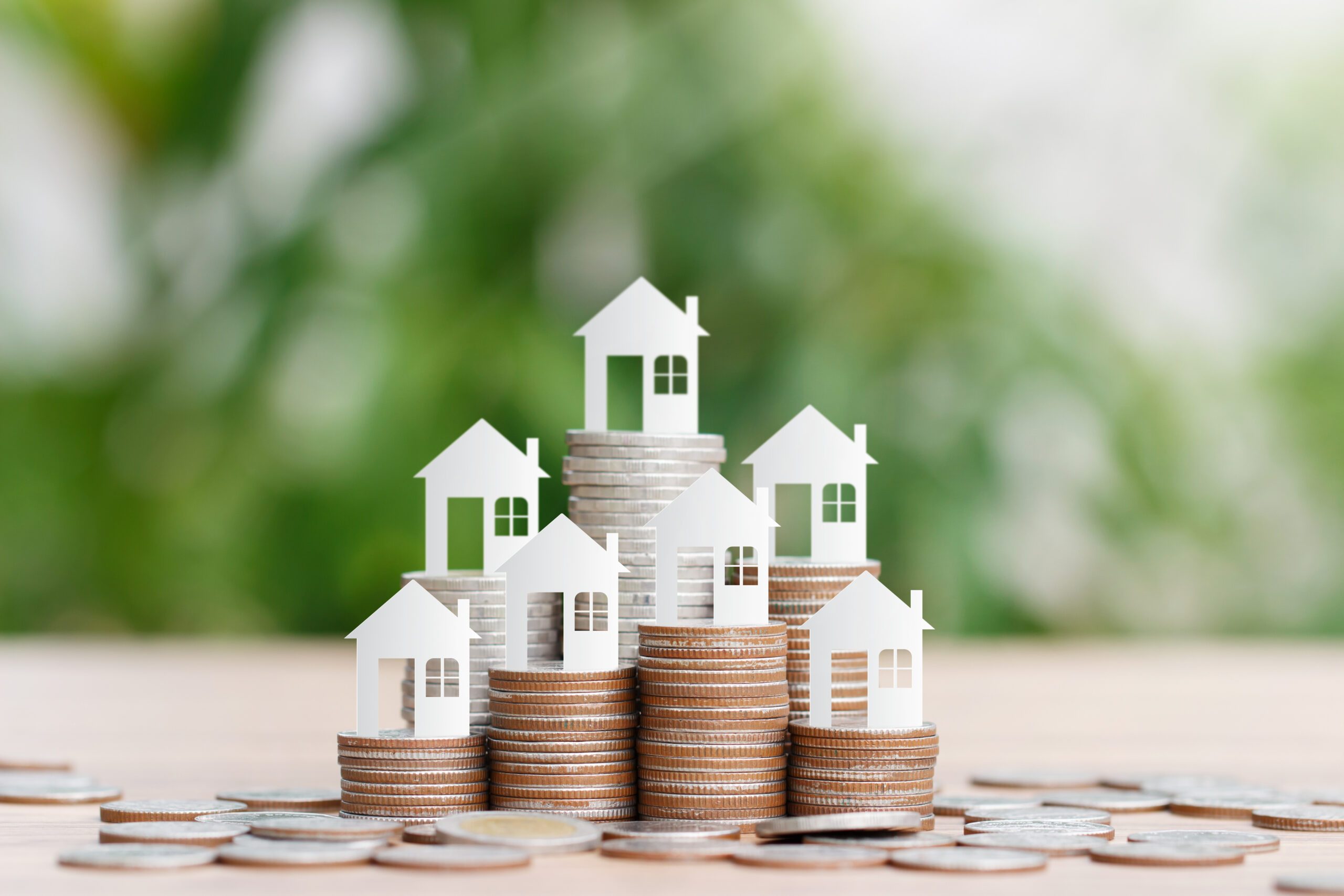House model on coins stack for saving to buy a house